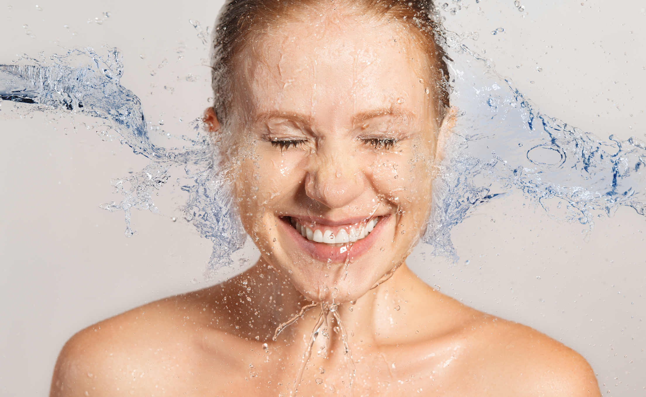 Happy beauty woman skin care, washing with splashes and drops of water